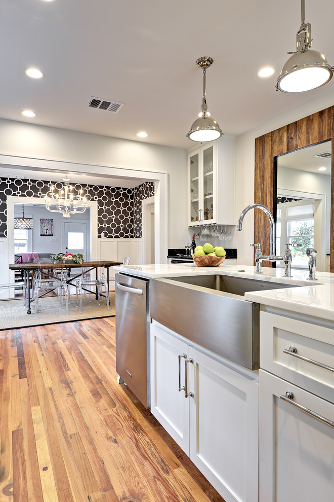 Example of a transitional eat-in kitchen design in Austin with marble countertops, stainless steel appliances and an island