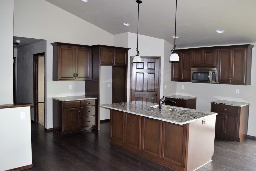 Kitchen - rustic kitchen idea with white cabinets, stainless steel appliances and an island