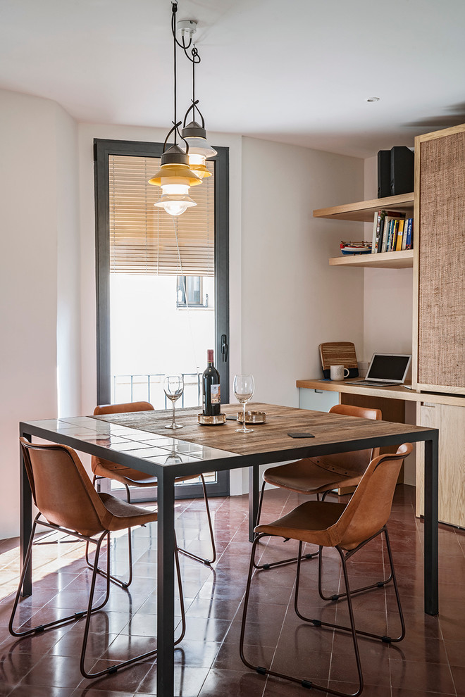 Inspiration for a small mediterranean open plan dining in Barcelona with white walls and concrete floors.