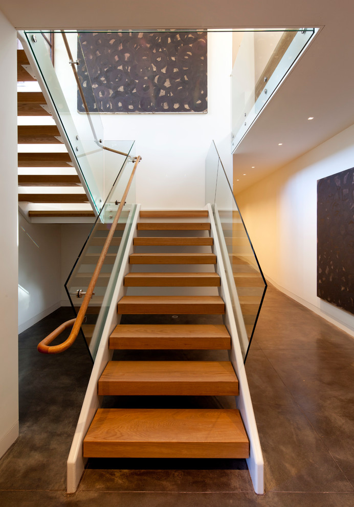 This is an example of a mid-sized modern wood u-shaped staircase in San Francisco with open risers.
