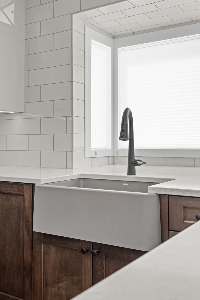 Example of a transitional home design design in Calgary