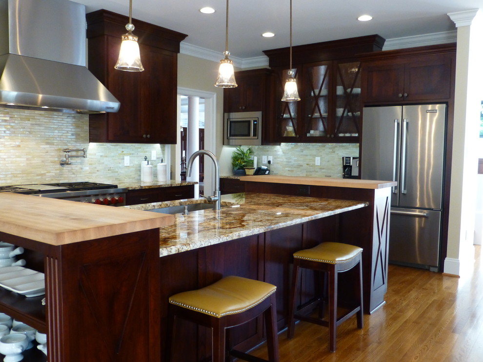 Example of a large transitional medium tone wood floor kitchen design in Richmond with recessed-panel cabinets, dark wood cabinets, granite countertops, beige backsplash, ceramic backsplash, stainless steel appliances and an island