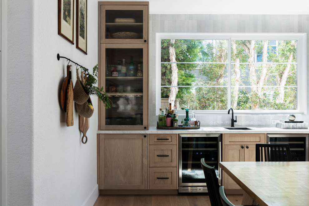 Example of a large transitional eat-in kitchen design in San Diego with an island