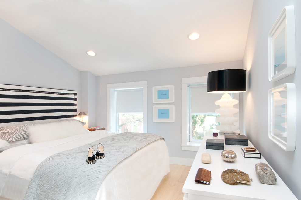 Design ideas for a small contemporary master bedroom in Bridgeport with light hardwood floors, no fireplace and grey walls.