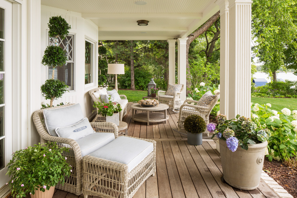 This is an example of a coastal veranda in Minneapolis with a potted garden, decking and a roof extension.