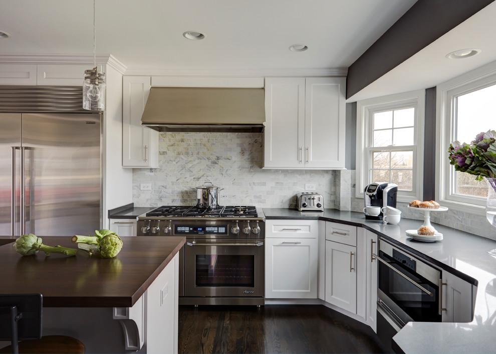 Eat-in kitchen - large transitional dark wood floor eat-in kitchen idea in Chicago with a single-bowl sink, shaker cabinets, white cabinets, quartz countertops, white backsplash, stone tile backsplash, stainless steel appliances and two islands