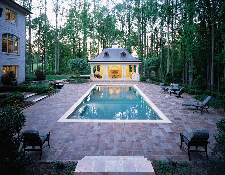 Inspiration for a mid-sized traditional backyard rectangular lap pool in DC Metro with brick pavers.