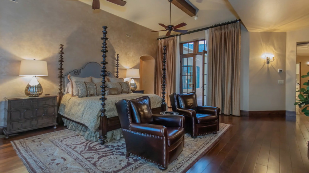 Large tuscan master medium tone wood floor bedroom photo in Phoenix with beige walls