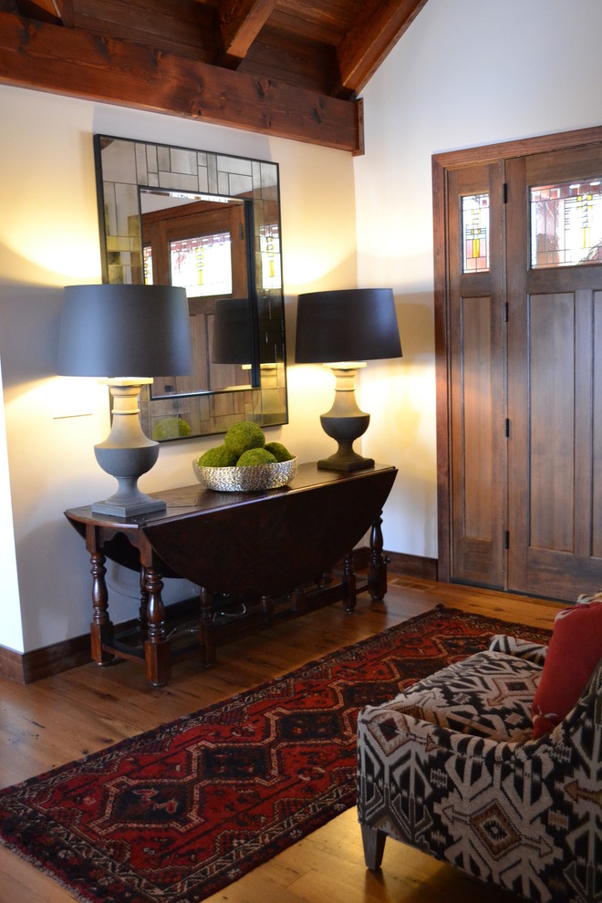 Front door - rustic medium tone wood floor front door idea with white walls and a medium wood front door