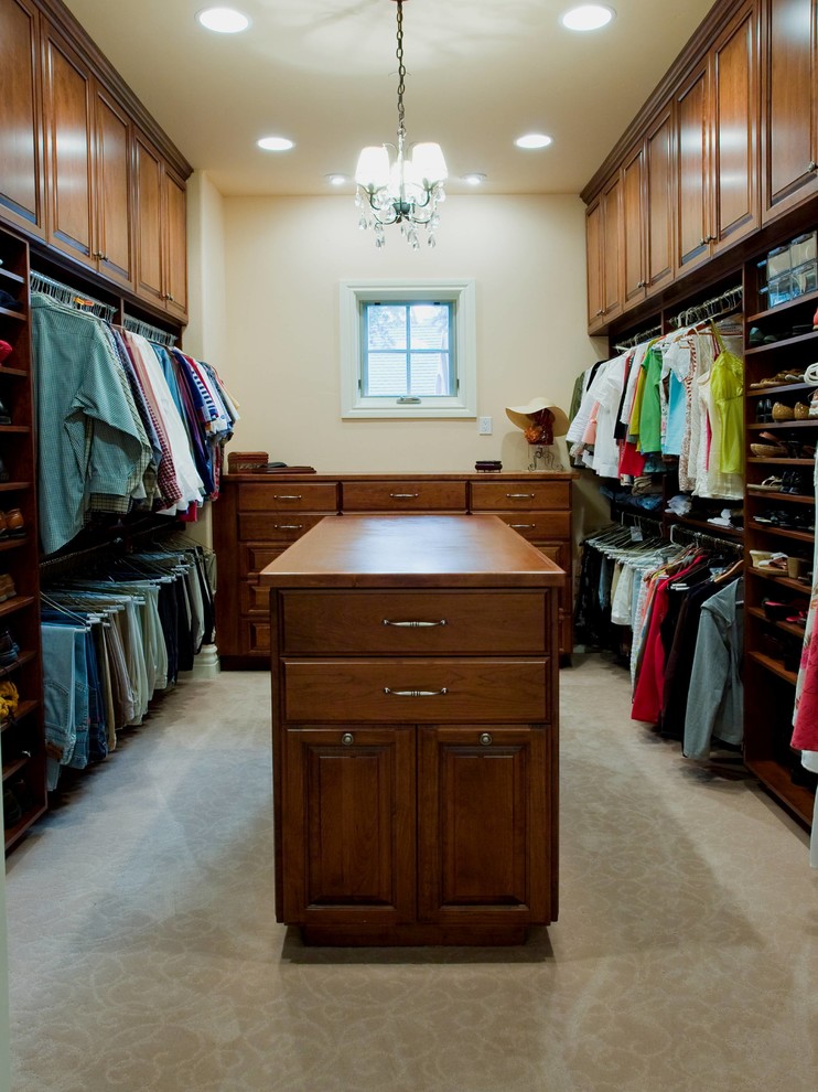 Large traditional walk-in wardrobe in Portland with medium wood cabinets, carpet, beige floor and raised-panel cabinets.