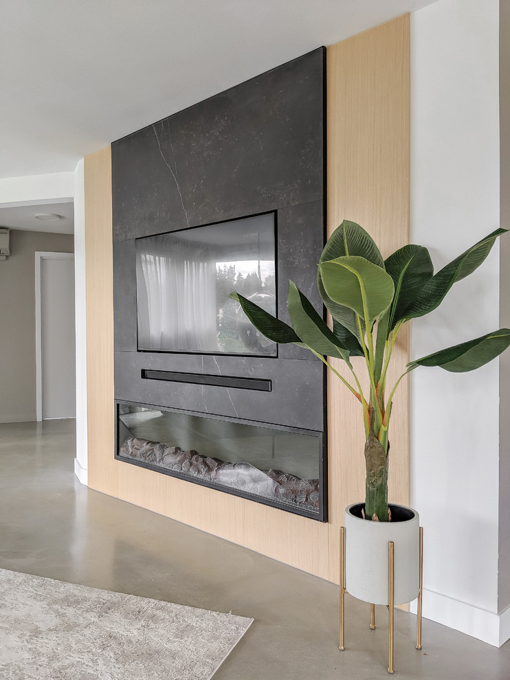Inspiration for a contemporary living room in Seattle with white walls, a standard fireplace, a metal fireplace surround, a built-in media wall and grey floor.