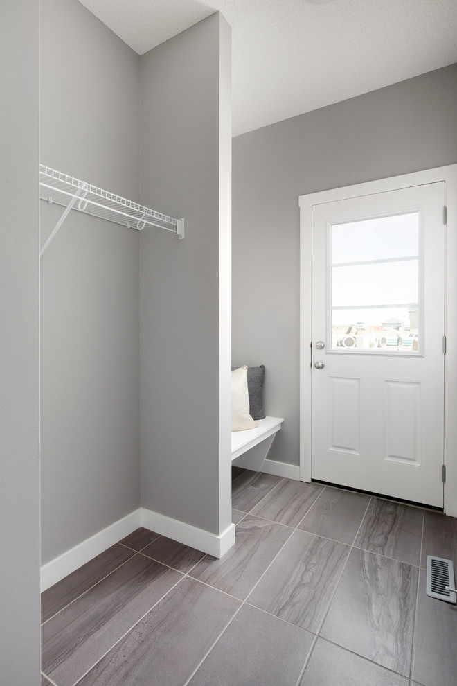 Photo of a mid-sized contemporary mudroom in Calgary with grey walls, ceramic floors, a pivot front door and a white front door.