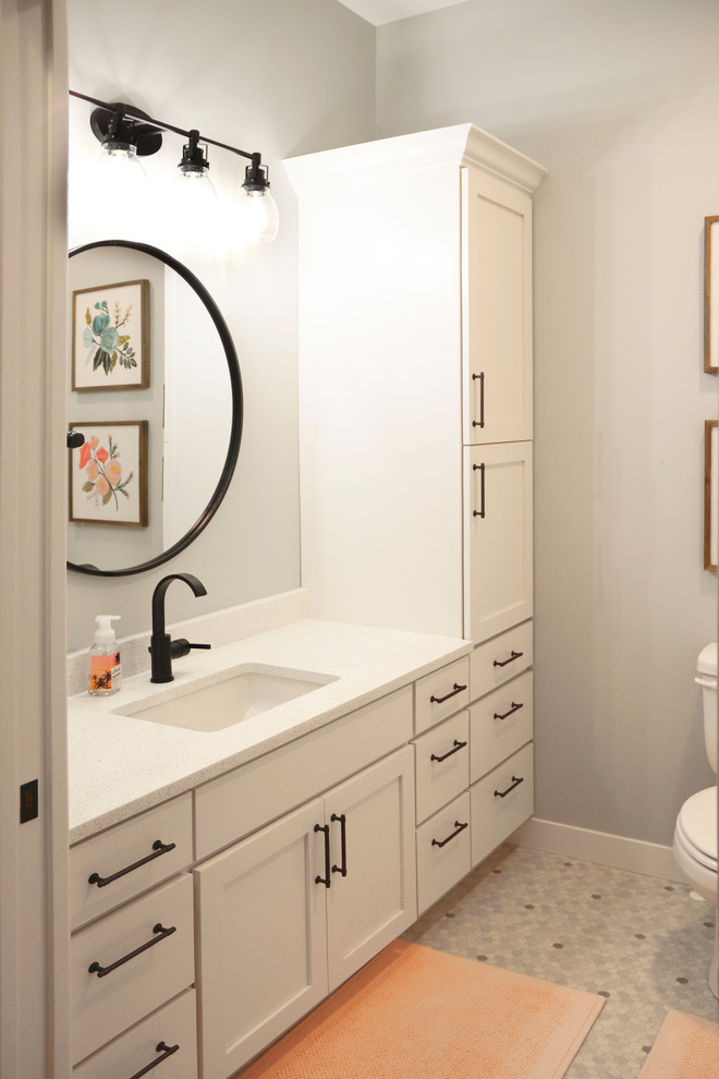 Photo of a large country 3/4 bathroom in Other with shaker cabinets, white cabinets, an alcove shower, gray tile, porcelain tile, grey walls, an undermount sink, engineered quartz benchtops, white benchtops, a two-piece toilet, mosaic tile floors, multi-coloured floor and a shower curtain.