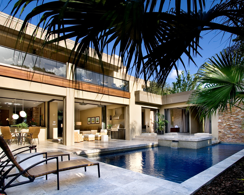 Design ideas for a contemporary rectangular pool in Orlando with a water feature.