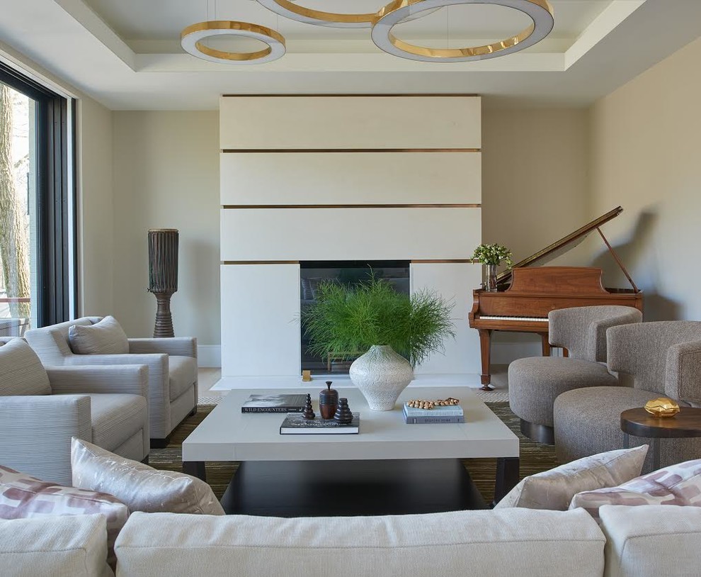 Photo of a mid-sized contemporary enclosed living room in DC Metro with a music area, beige walls, a standard fireplace, no tv, a plaster fireplace surround and brown floor.