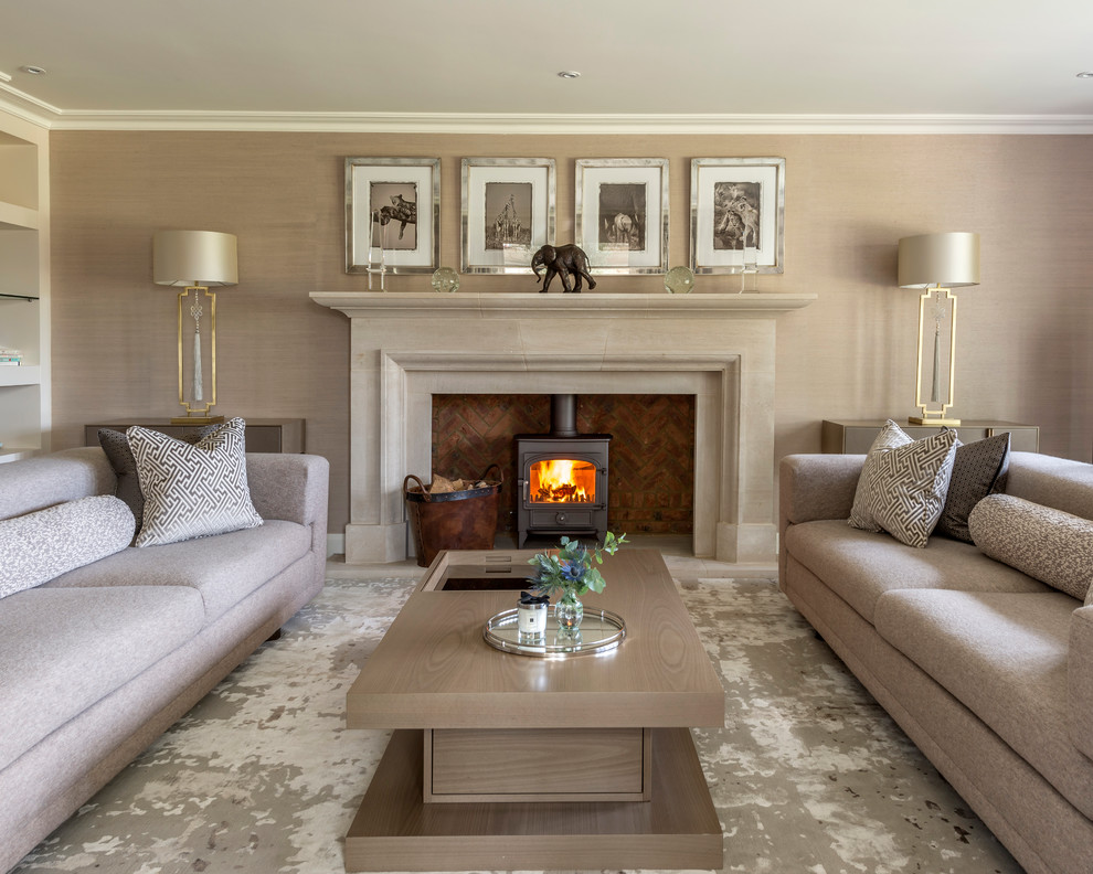 This is an example of a large transitional formal living room in Buckinghamshire with brown walls and a wood stove.
