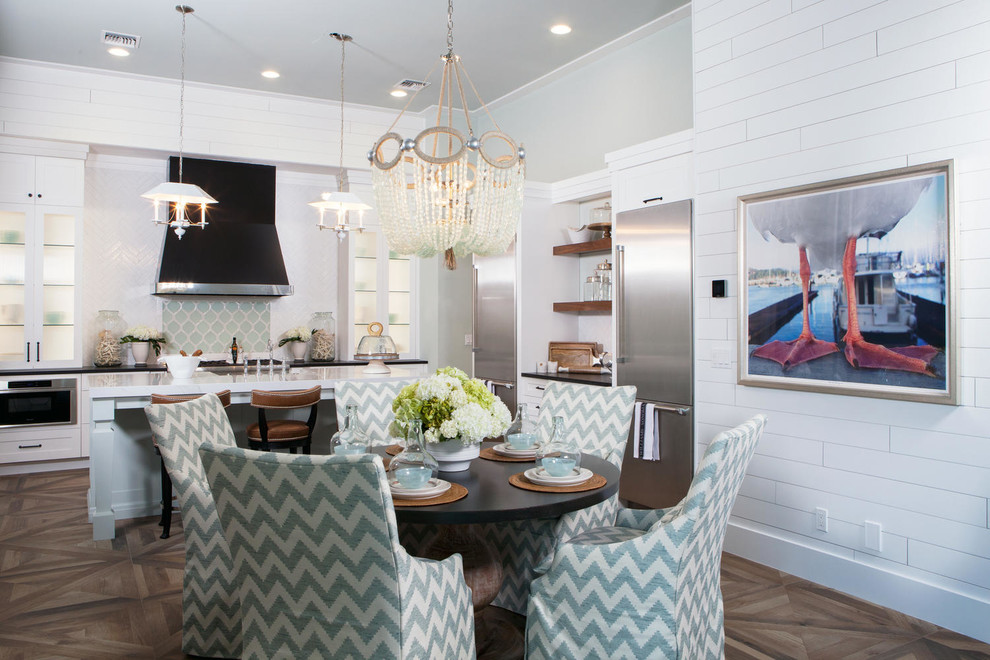 This is an example of a large beach style open plan dining in Miami with white walls, medium hardwood floors and brown floor.
