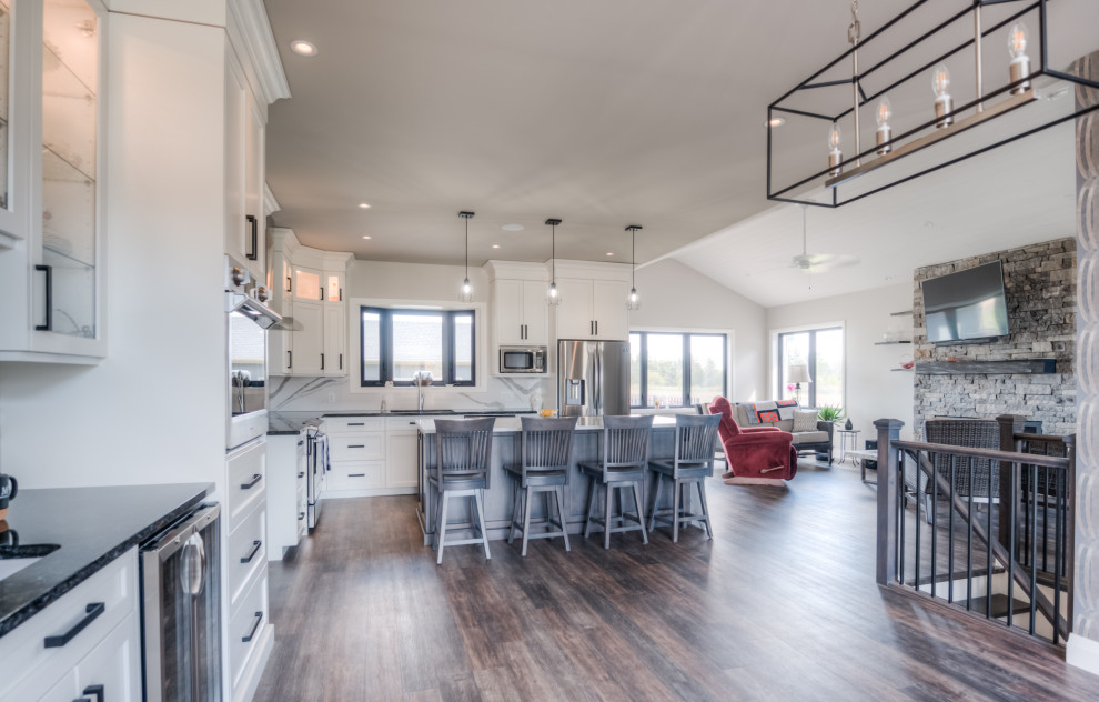 Transitional eat-in kitchen photo with shaker cabinets, white cabinets, stainless steel appliances and an island
