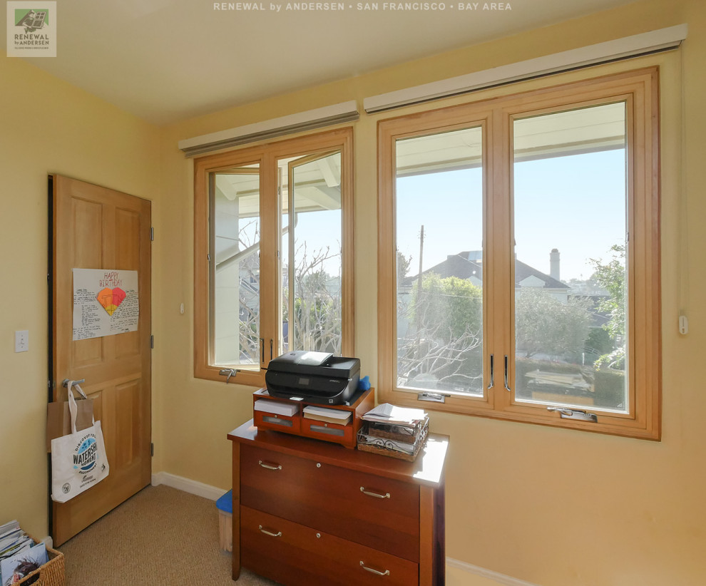 This is an example of a mid-sized home office in San Francisco with yellow walls, carpet, no fireplace, a freestanding desk, beige floor and vaulted.