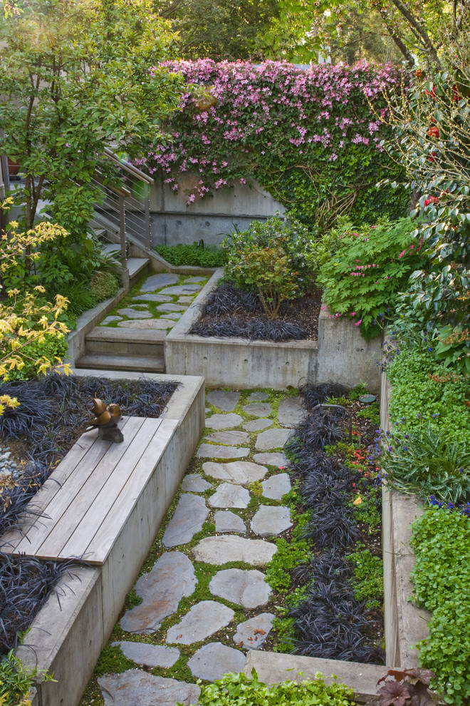Design ideas for a mediterranean backyard garden in Seattle with natural stone pavers.