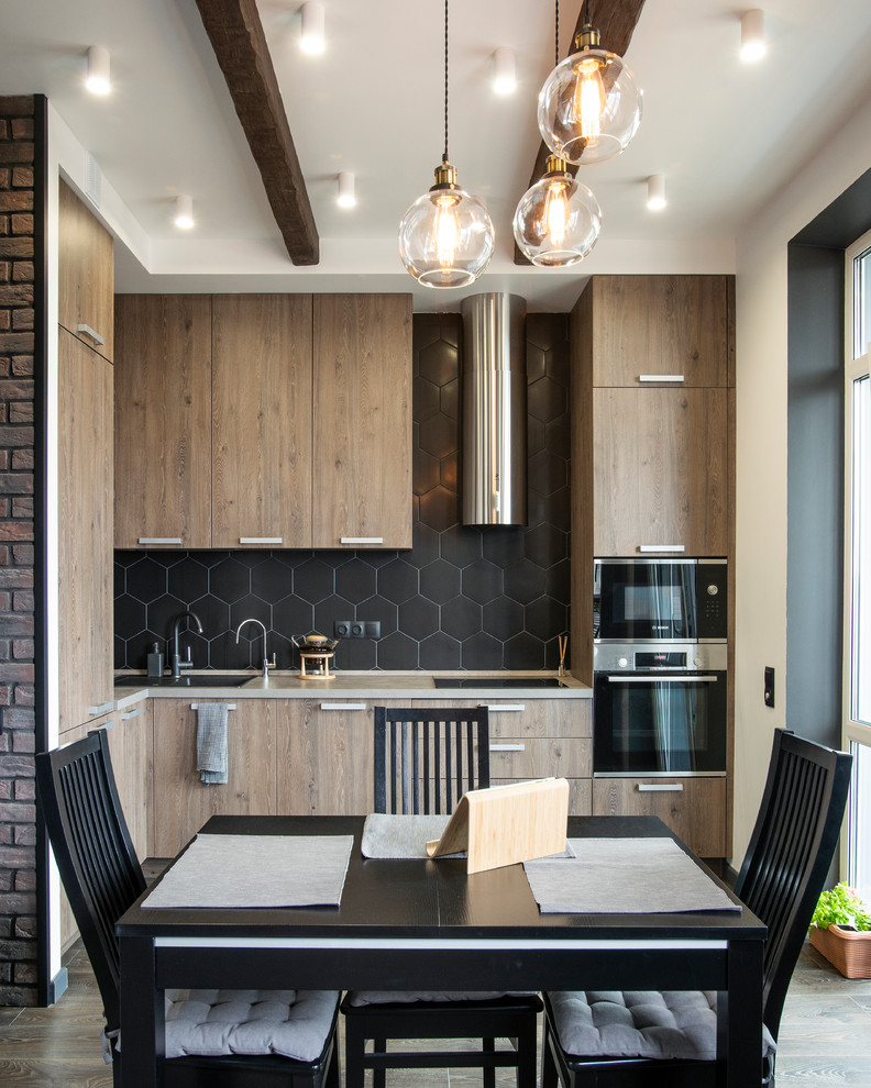 Photo of a contemporary eat-in kitchen in Moscow with an undermount sink, flat-panel cabinets, medium wood cabinets, black splashback, stainless steel appliances, medium hardwood floors, no island, brown floor and beige benchtop.