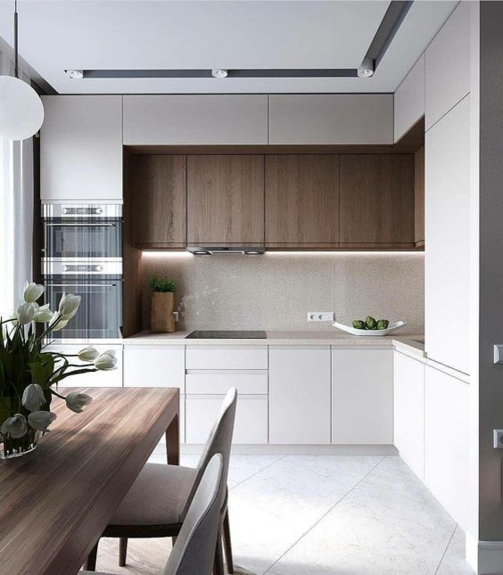 Inspiration for a medium sized modern grey and brown galley open plan kitchen in Austin with a built-in sink, flat-panel cabinets, white splashback, cement tile splashback, an island, grey floors, all types of ceiling, light wood cabinets, wood worktops, integrated appliances, cement flooring and grey worktops.
