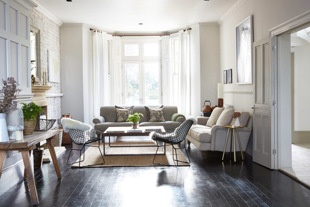 Inspiration for a transitional formal living room in London with white walls and dark hardwood floors.