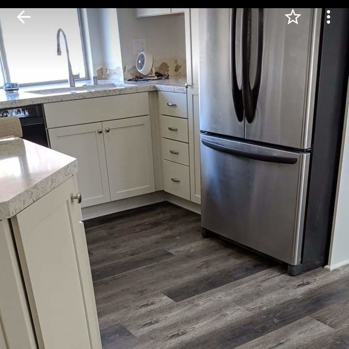 Large transitional u-shaped dark wood floor and brown floor eat-in kitchen photo in Los Angeles with an undermount sink, recessed-panel cabinets, gray cabinets, quartzite countertops, white backsplash, ceramic backsplash, stainless steel appliances, an island and white countertops