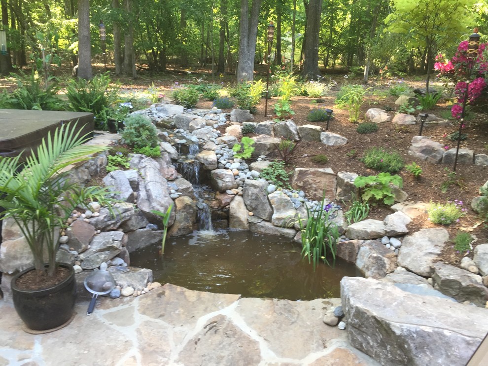 Photo of a small traditional backyard shaded garden in Raleigh with a water feature and natural stone pavers.