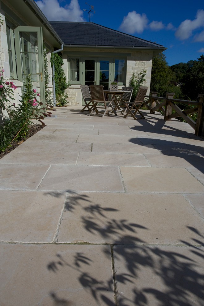 Inspiration for a country patio in Wiltshire with natural stone pavers.