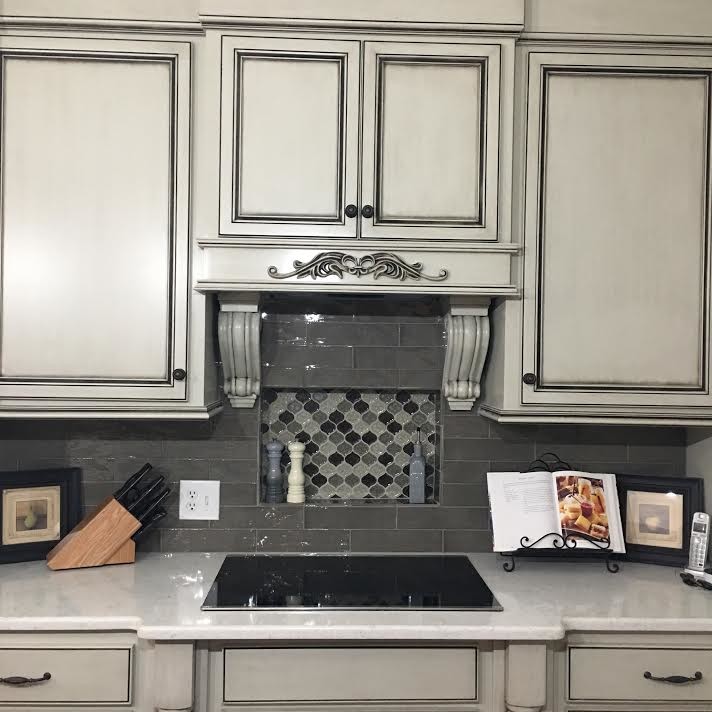 Inspiration for a mid-sized transitional single-wall dark wood floor and brown floor open concept kitchen remodel in Birmingham with an undermount sink, raised-panel cabinets, gray cabinets, gray backsplash, stainless steel appliances and an island