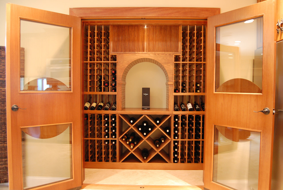 Inspiration for a mid-sized traditional wine cellar in Los Angeles with travertine floors, storage racks and beige floor.