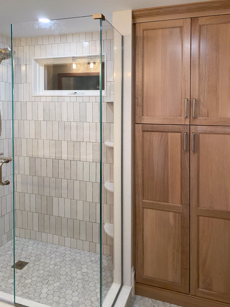This is an example of a traditional ensuite bathroom in Boston with green cabinets, a corner shower, white tiles, ceramic tiles, porcelain flooring, engineered stone worktops, white floors, a hinged door, white worktops and a single sink.