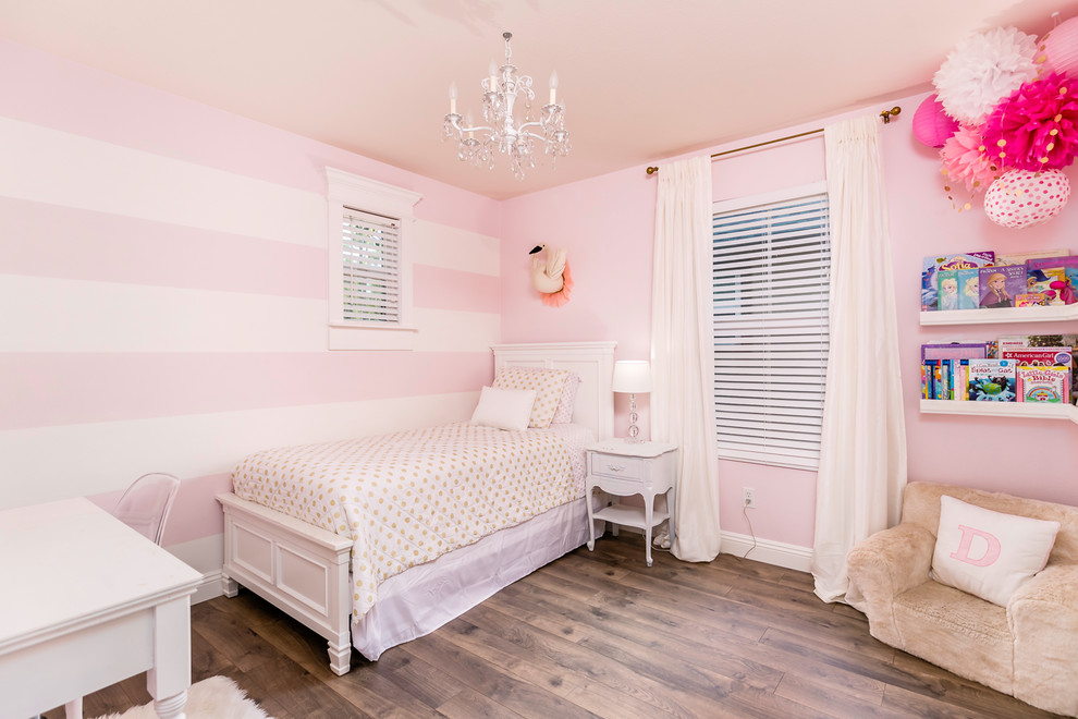 Design ideas for a traditional bedroom in Dallas with pink walls and laminate floors.