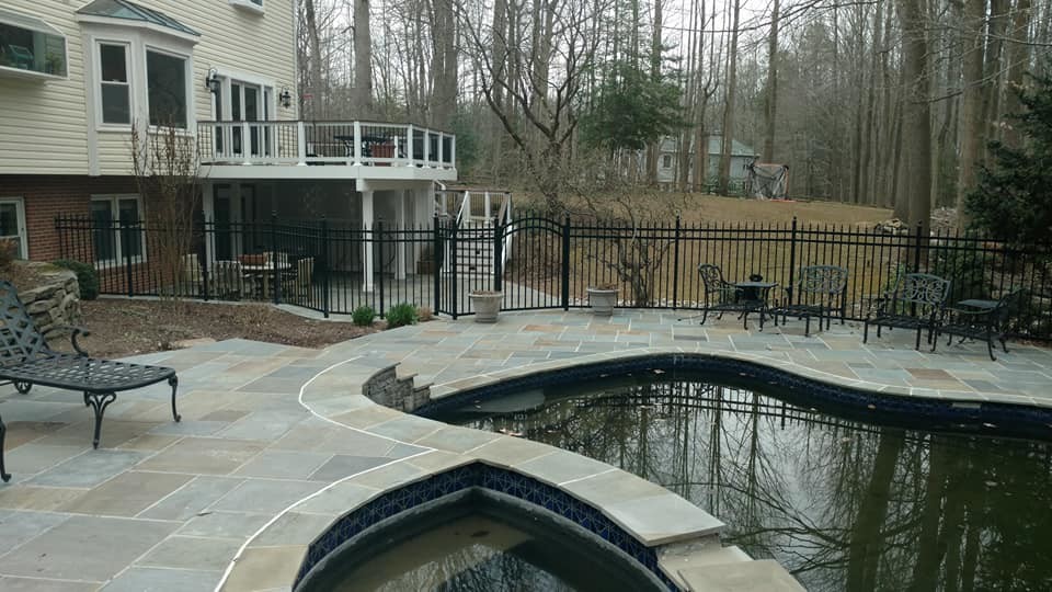 Example of a huge transitional backyard stone and kidney-shaped natural pool design