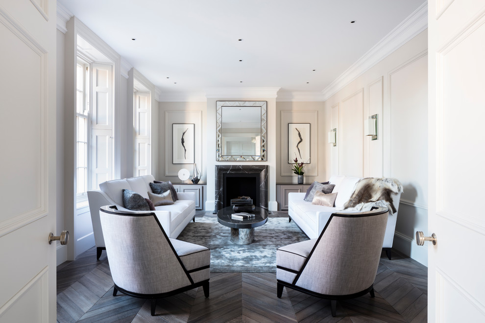 Inspiration for a mid-sized contemporary formal enclosed living room in London with dark hardwood floors, a stone fireplace surround, beige walls, a standard fireplace and no tv.