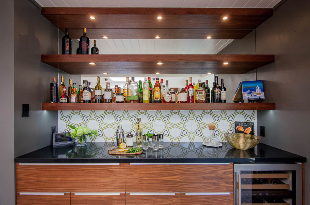 Design ideas for a mid-sized midcentury galley home bar in San Francisco with an undermount sink, flat-panel cabinets, medium wood cabinets, quartz benchtops, multi-coloured splashback, ceramic splashback, ceramic floors and grey floor.