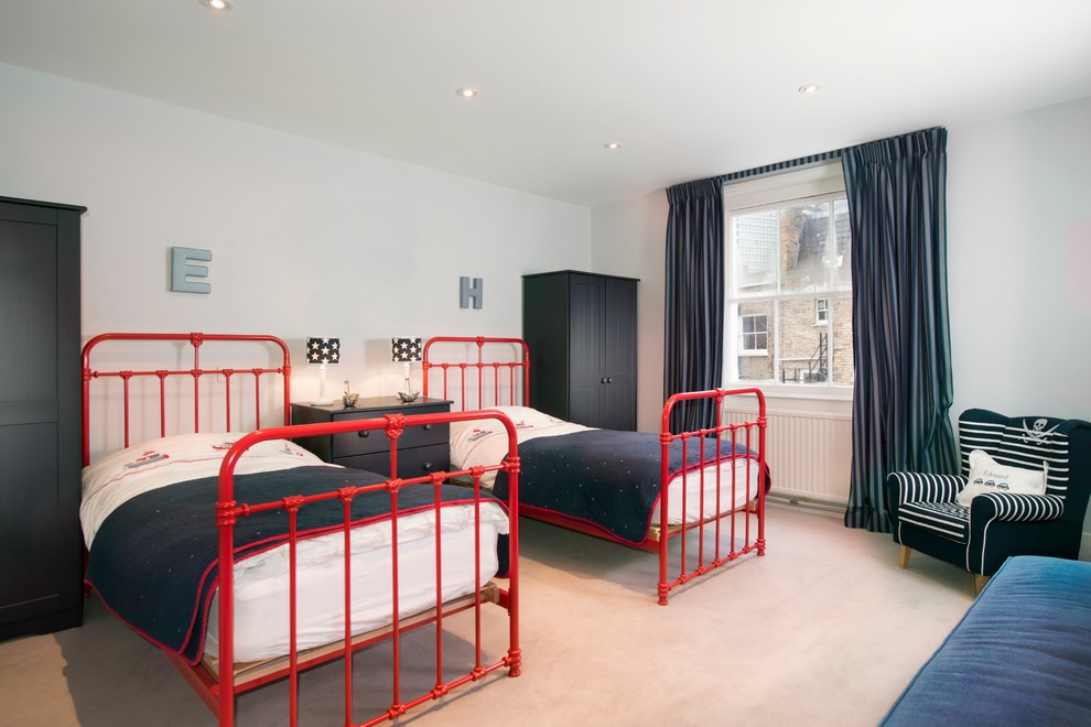This is an example of a large gender-neutral kids' room in London with carpet and white walls.