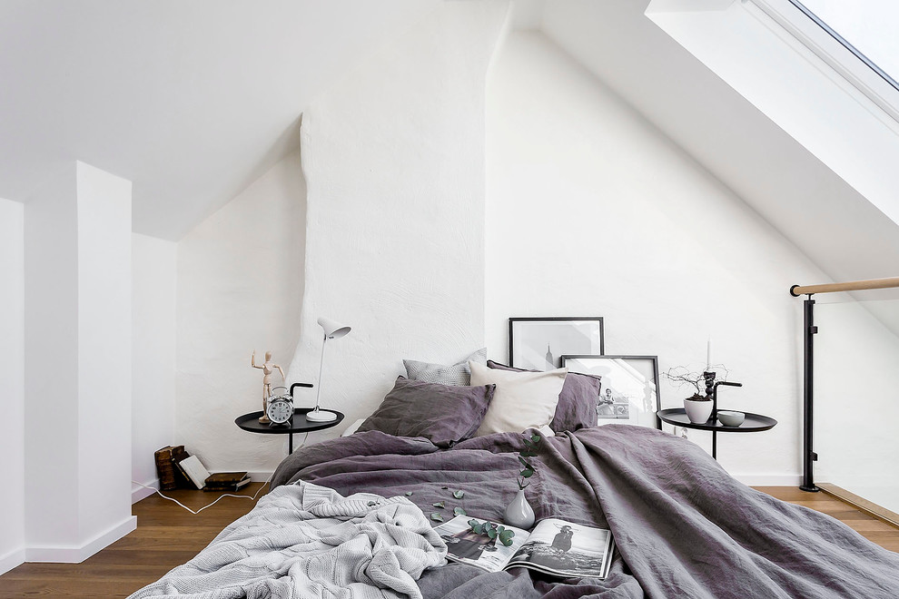 Design ideas for a large scandinavian master bedroom in Stockholm with white walls, light hardwood floors and no fireplace.