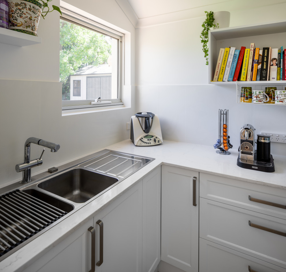 Elegant kitchen photo in Perth with a drop-in sink, shaker cabinets, white cabinets, quartz countertops, white backsplash, ceramic backsplash and beige countertops