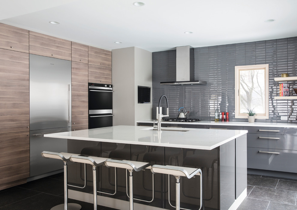 Kitchen - contemporary l-shaped gray floor kitchen idea in Orange County with an undermount sink, flat-panel cabinets, gray cabinets, gray backsplash, stainless steel appliances, an island and white countertops