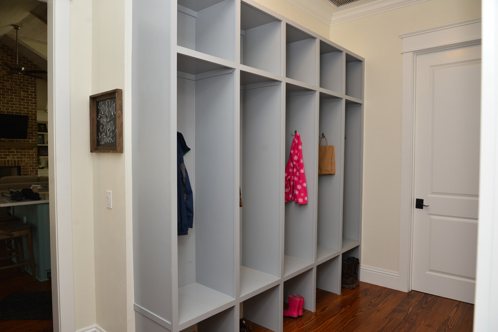 Design ideas for a mid-sized country mudroom in Atlanta with medium hardwood floors, a single front door, a white front door and yellow walls.