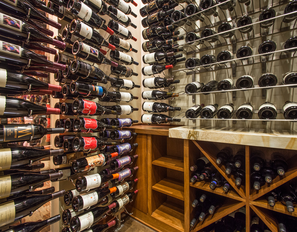 Large transitional concrete floor wine cellar photo in Dallas with storage racks