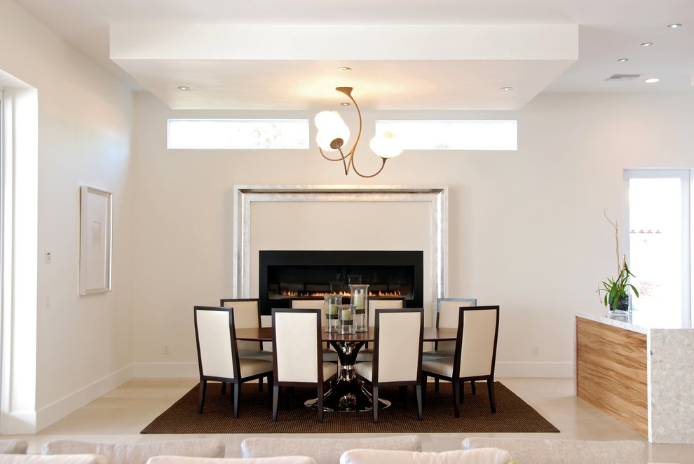Photo of a contemporary dining room in Tampa with white walls and a ribbon fireplace.