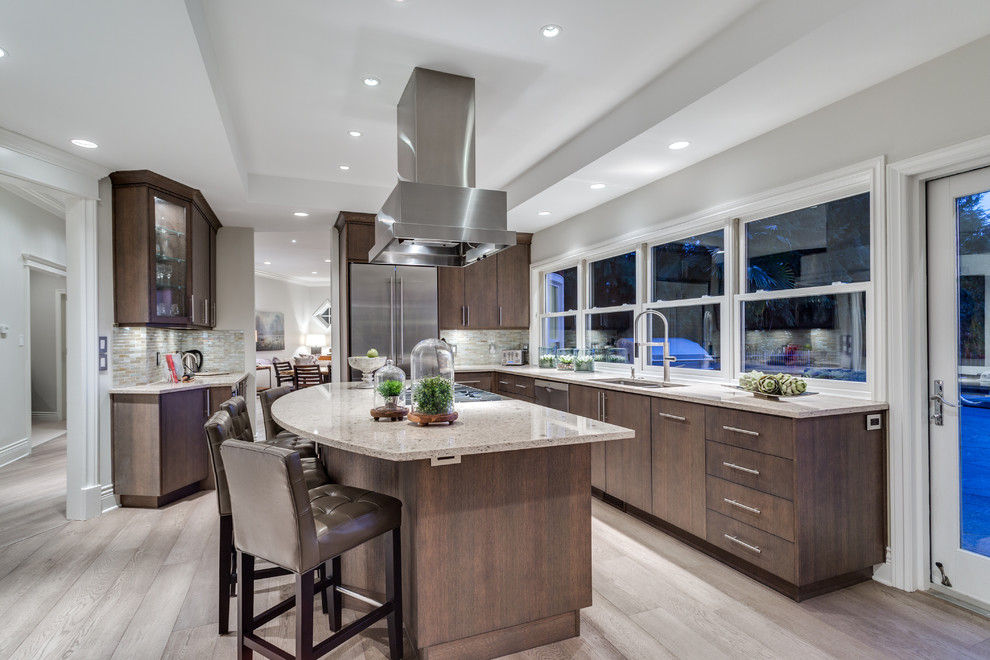 Design ideas for a mid-sized contemporary l-shaped open plan kitchen in Vancouver with an undermount sink, flat-panel cabinets, medium wood cabinets, quartz benchtops, multi-coloured splashback, glass tile splashback, stainless steel appliances, light hardwood floors and with island.