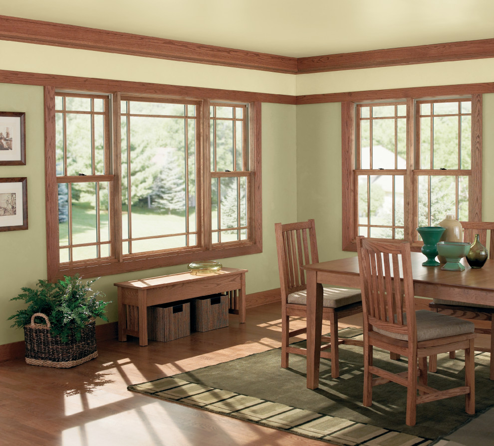 Mountain style brown floor kitchen/dining room combo photo in Burlington with green walls and no fireplace
