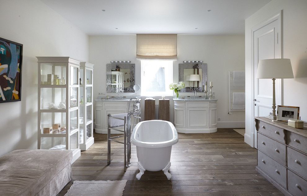 Design ideas for a contemporary master bathroom in Moscow with raised-panel cabinets, white cabinets, a claw-foot tub, white walls, medium hardwood floors and grey benchtops.