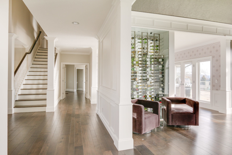 This is an example of a contemporary wine cellar in Portland with medium hardwood floors and display racks.