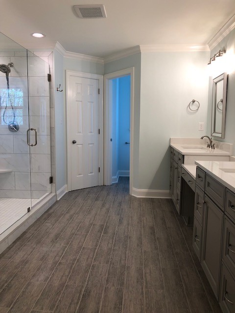 Alcove shower - mid-sized transitional master white tile and porcelain tile porcelain tile and gray floor alcove shower idea with recessed-panel cabinets, gray cabinets, a two-piece toilet, an undermount sink, quartzite countertops, a hinged shower door and white countertops