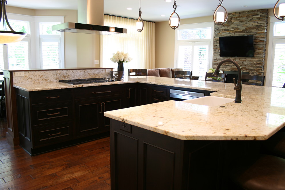 Mid-sized traditional u-shaped open plan kitchen in Other with recessed-panel cabinets, granite benchtops and with island.